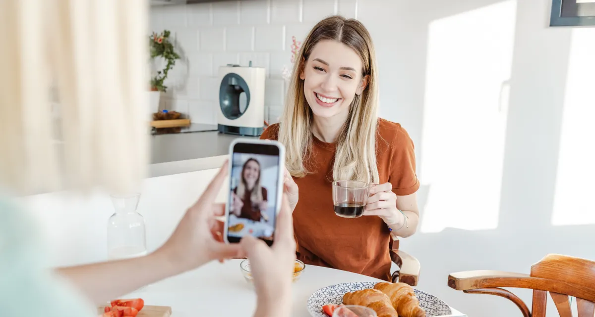 Health and wellness coach creating conversion content on phone that generates leads and consultation bookings — Client Flow Framework by Shapei Tragico
