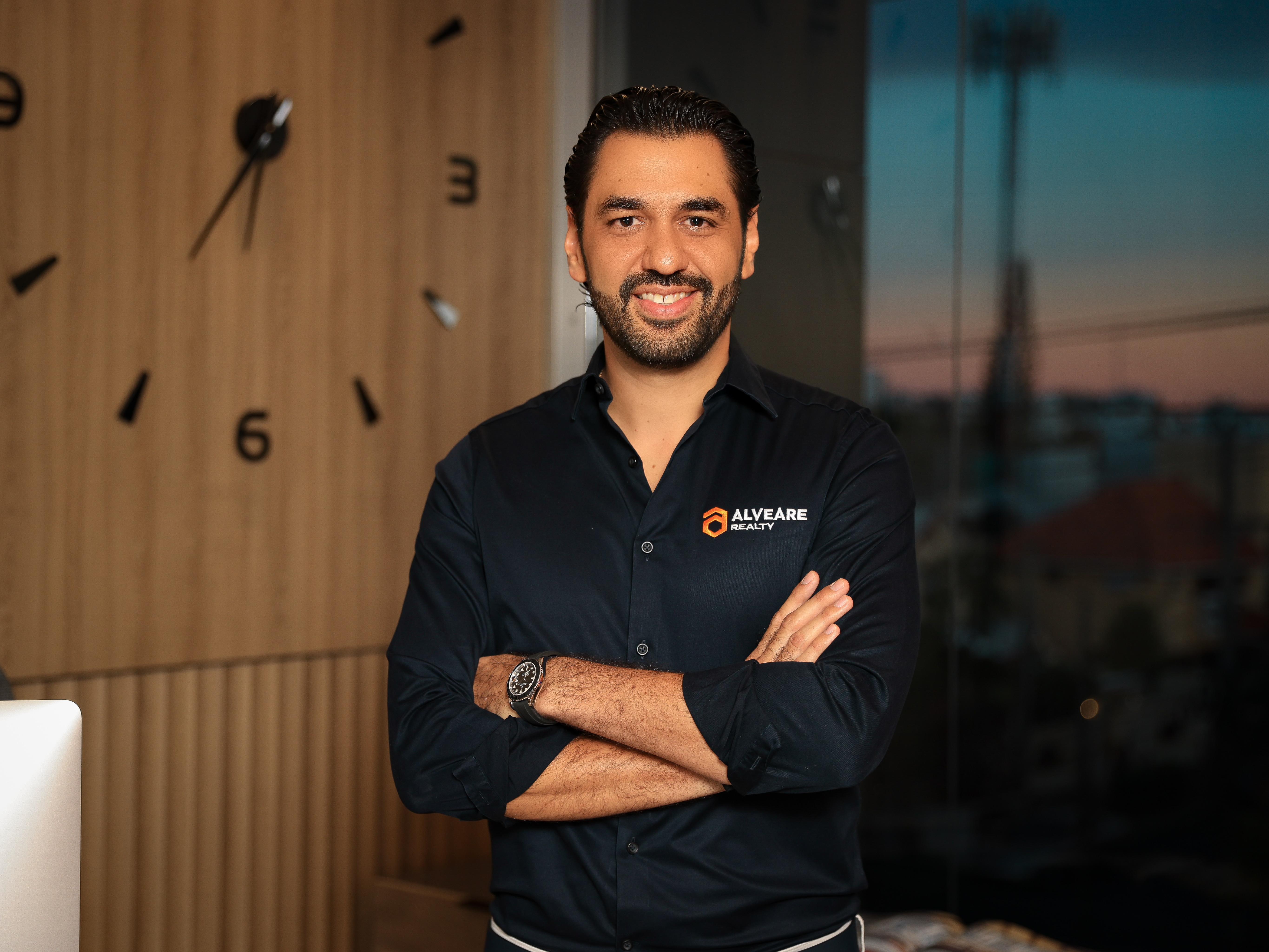 a living room filled with furniture and a kitchen
