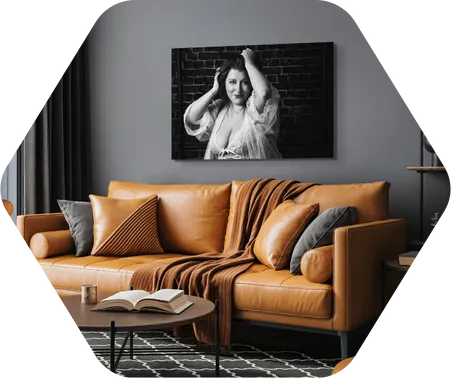 Photo of a woman in lingerie on a wall with a brown couch Enchanted Boudoir Indianapolis