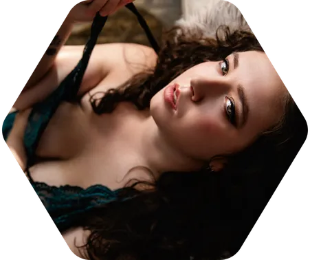 A brunette wdoman in black lingerie poses for a boudoir shoot in Indianapolis at Enchanted Moments Artistry