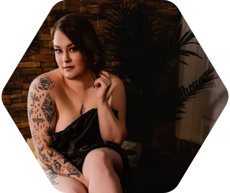 A brunette woman in black lingerie poses for a boudoir shoot in Indianapolis at Enchanted Moments Artistry