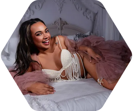 A woman in white beaded lingerie poses for a boudoir shoot in Indianapolis at Enchanted Moments Artistry