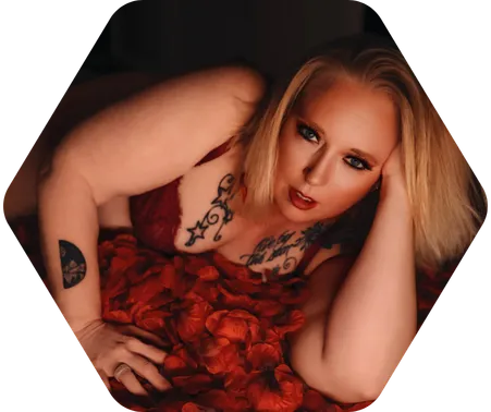 A blonde woman in red lingerie poses for a boudoir shoot in Indianapolis at Enchanted Moments Artistry