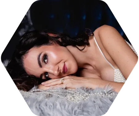 A woman in white beaded lingerie poses for a boudoir shoot in Indianapolis at Enchanted Moments Artistry