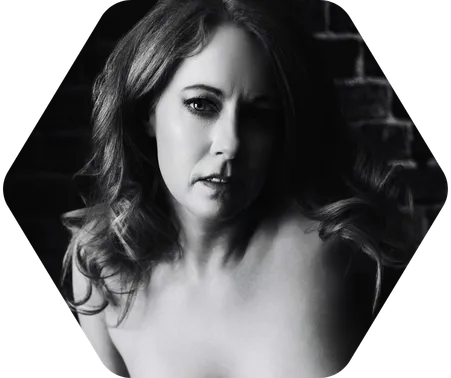A woman poses topless for a black-and-white boudoir shoot in Indianapolis at Enchanted Moments Artistry