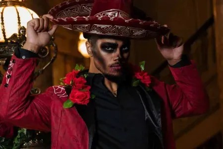 Conceptual portrait of a man in a red jacket and sombrero with skull face paint, Indianapolis conceptual photography