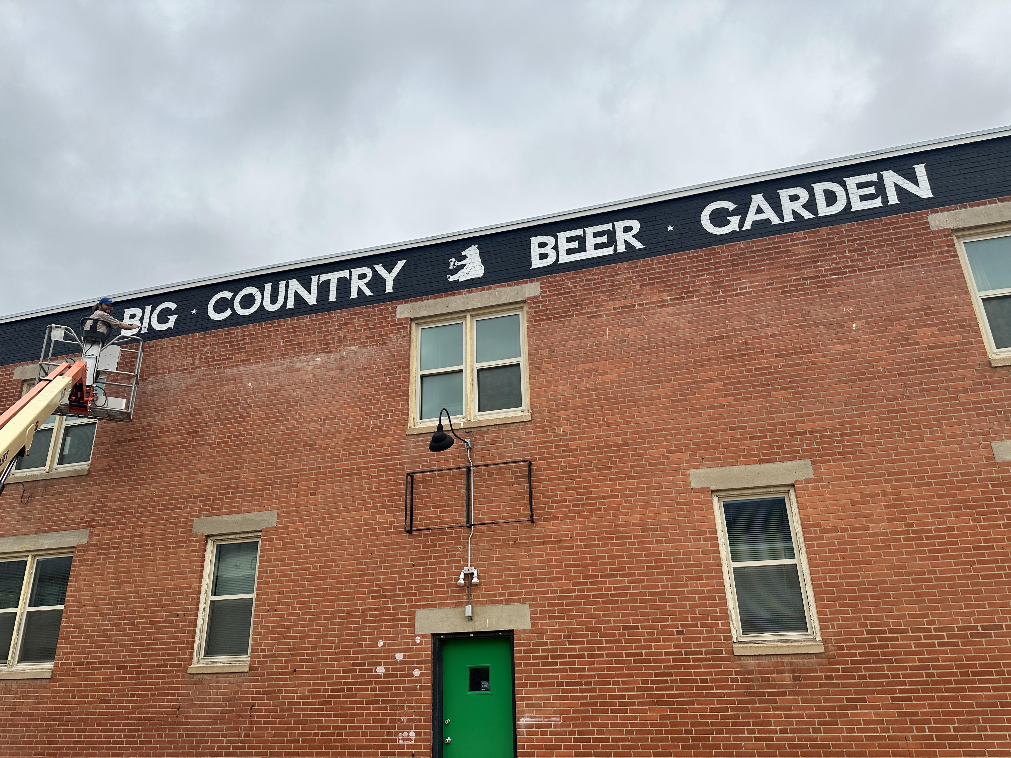 David Reynaud painting signage for a business in Abilene
