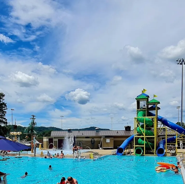 large outdoor pool with water slides on a sunny day