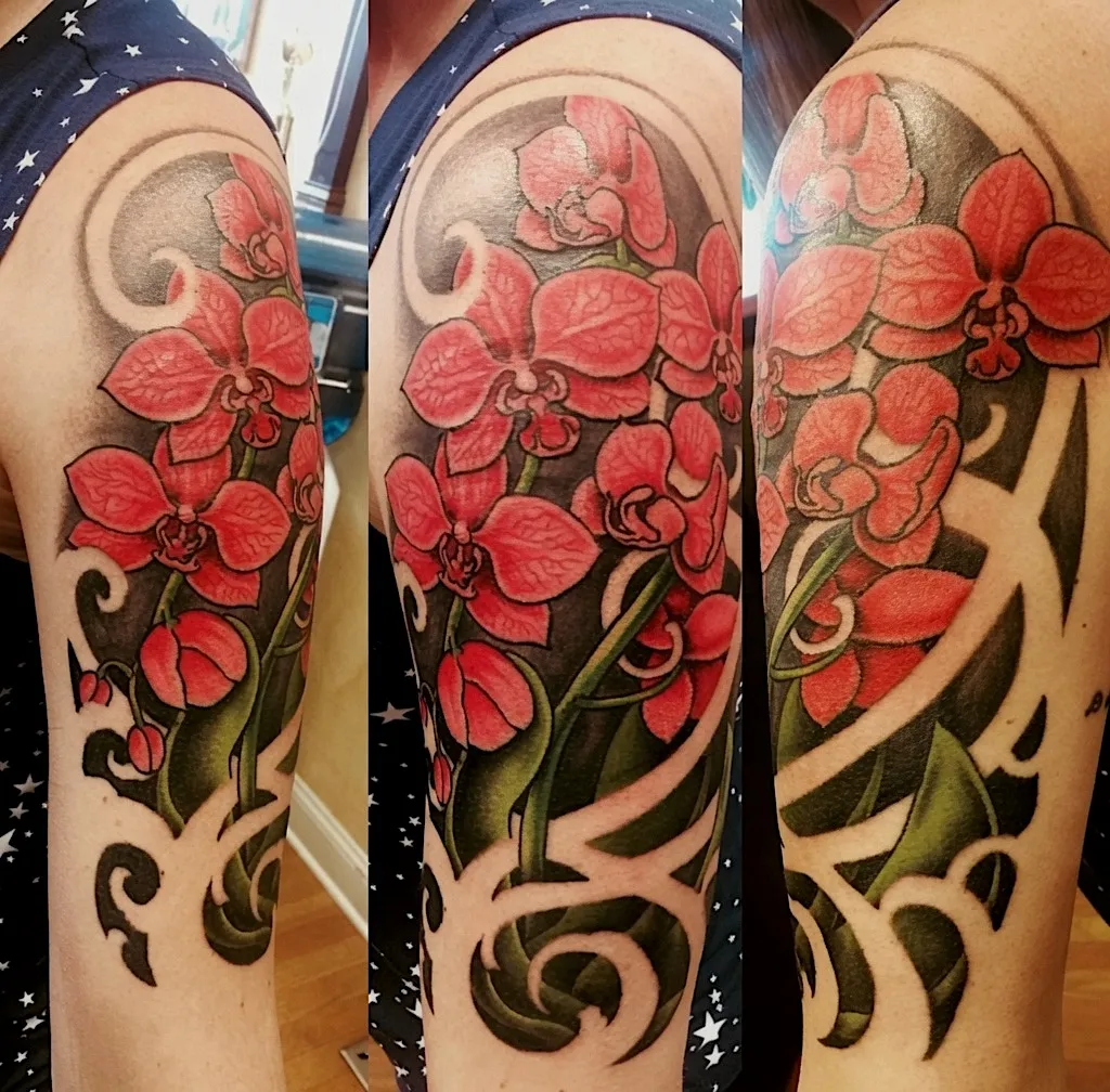 Red orchid tattoo with bold black and grey ornamental framing
