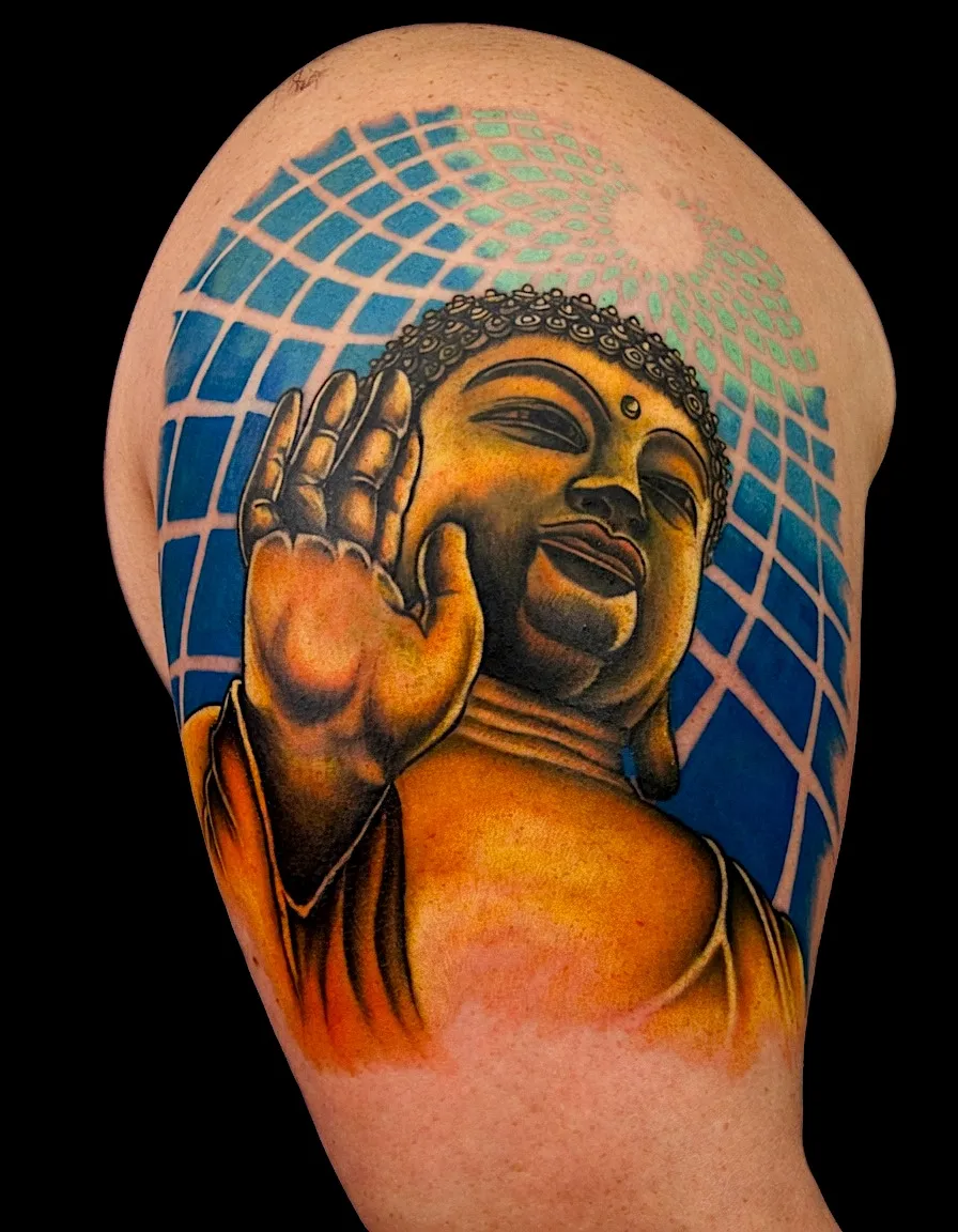 Golden Buddha portrait tattoo against a blue geometric background