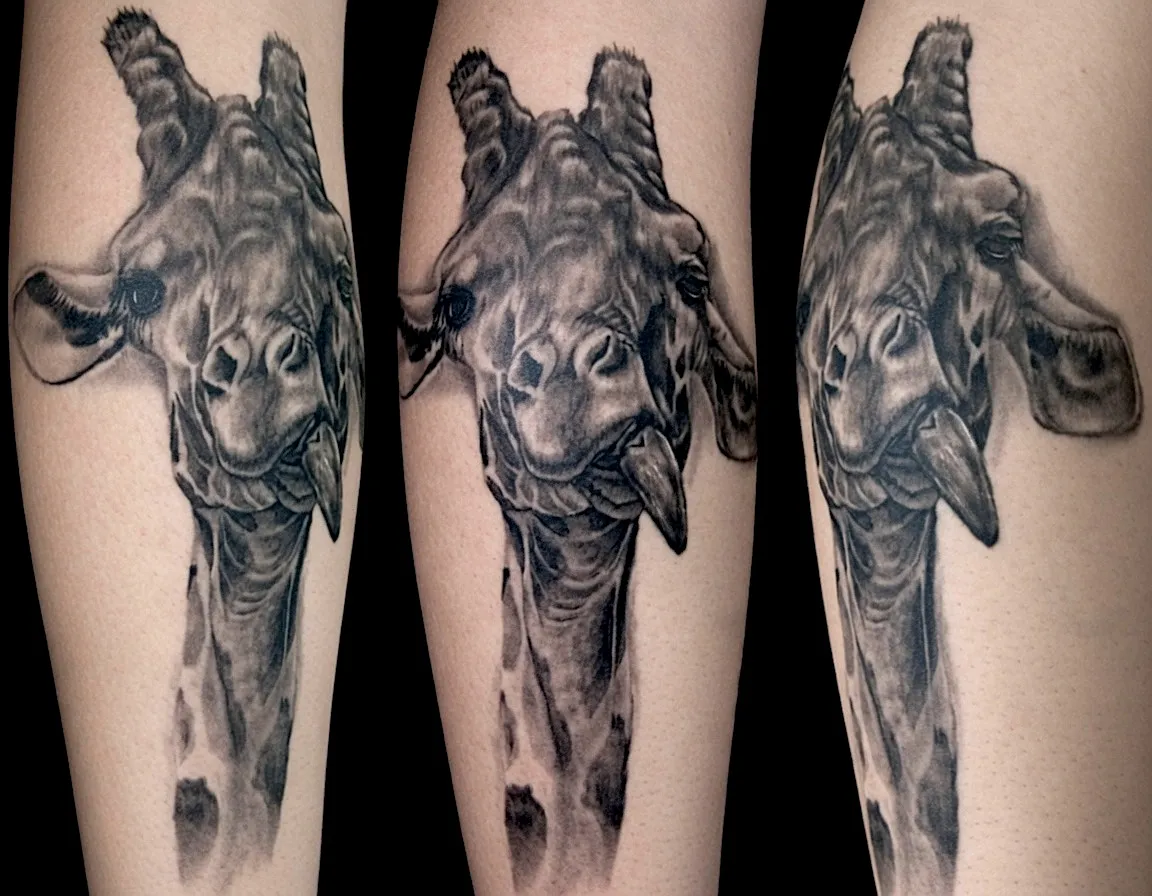 Black and grey giraffe portrait tattoo with a long neck