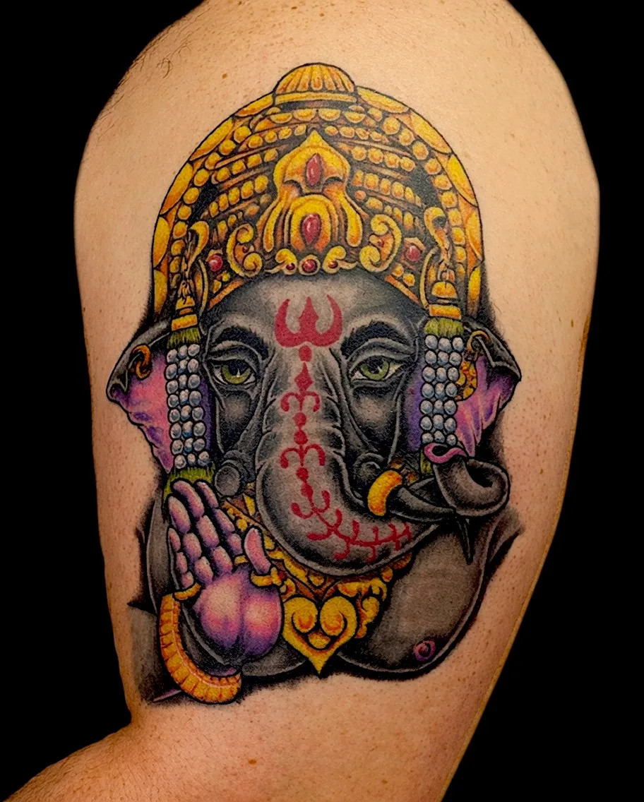 Color Ganesha tattoo with an ornate gold crown