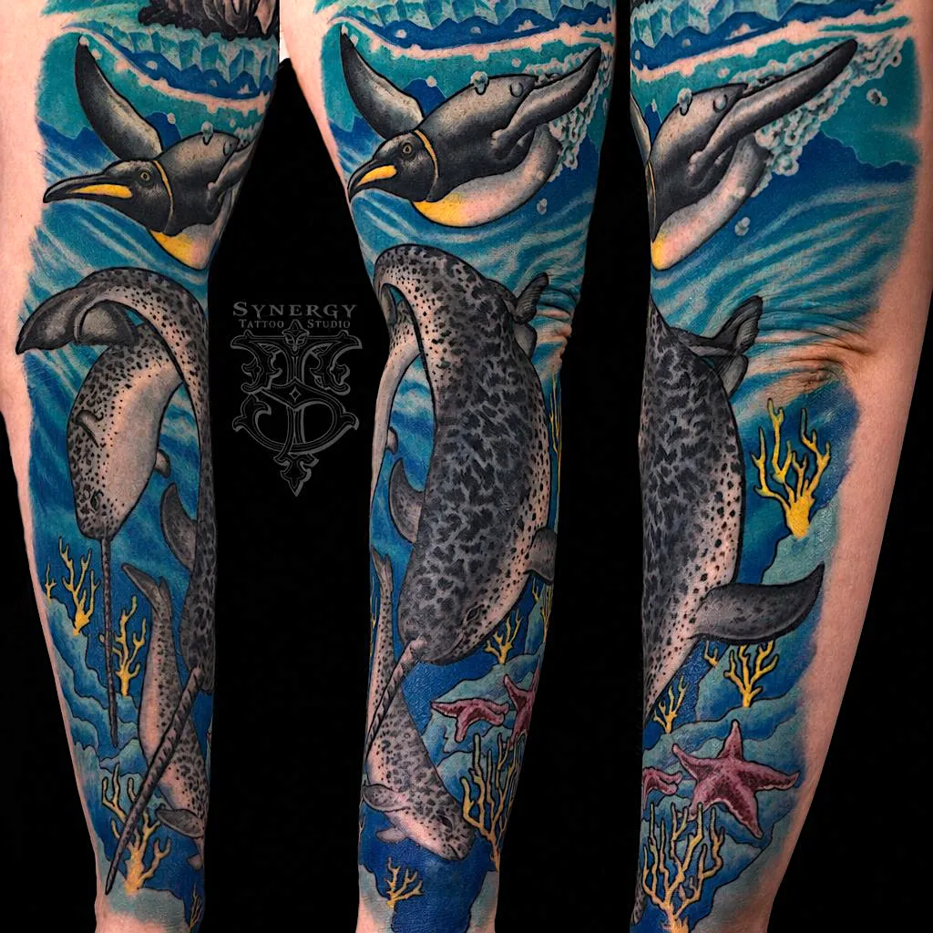 Blue ocean tattoo sleeve featuring marine animals, coral, and underwater scenery
