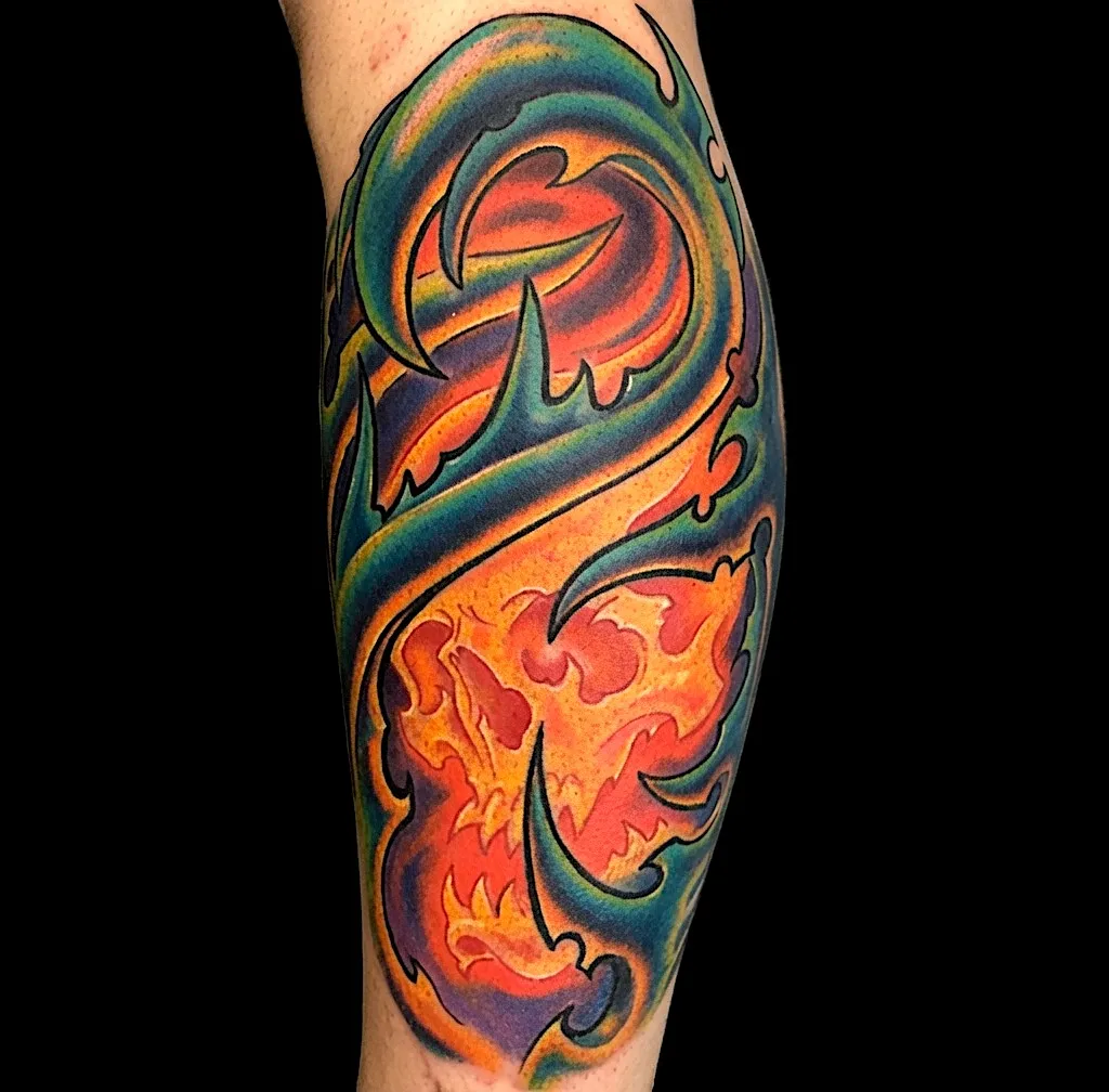 Orange flame tattoo framed by green and blue flowing shapes