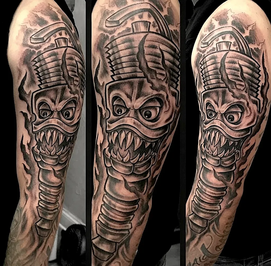 Black and grey skeletal microphone tattoo with a grinning skull