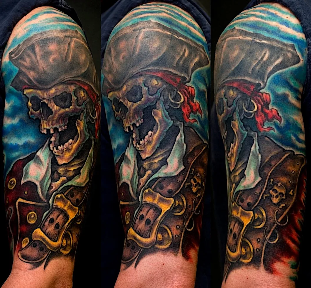Pirate skull tattoo with a tricorn hat, red headscarf, and flintlock pistol