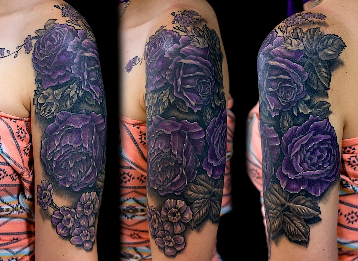 Purple rose tattoo with dark green leaves and decorative beadwork