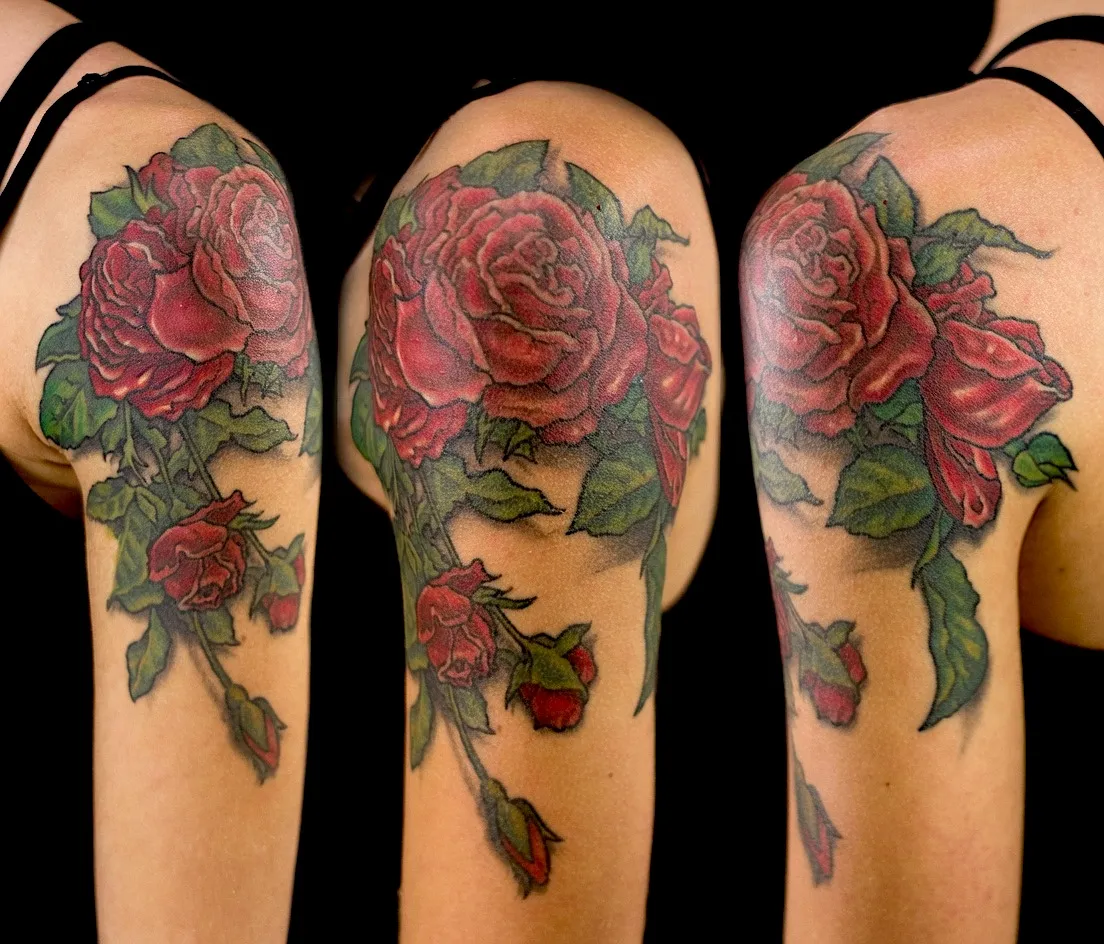 Red rose and rosebud tattoo with green leaves