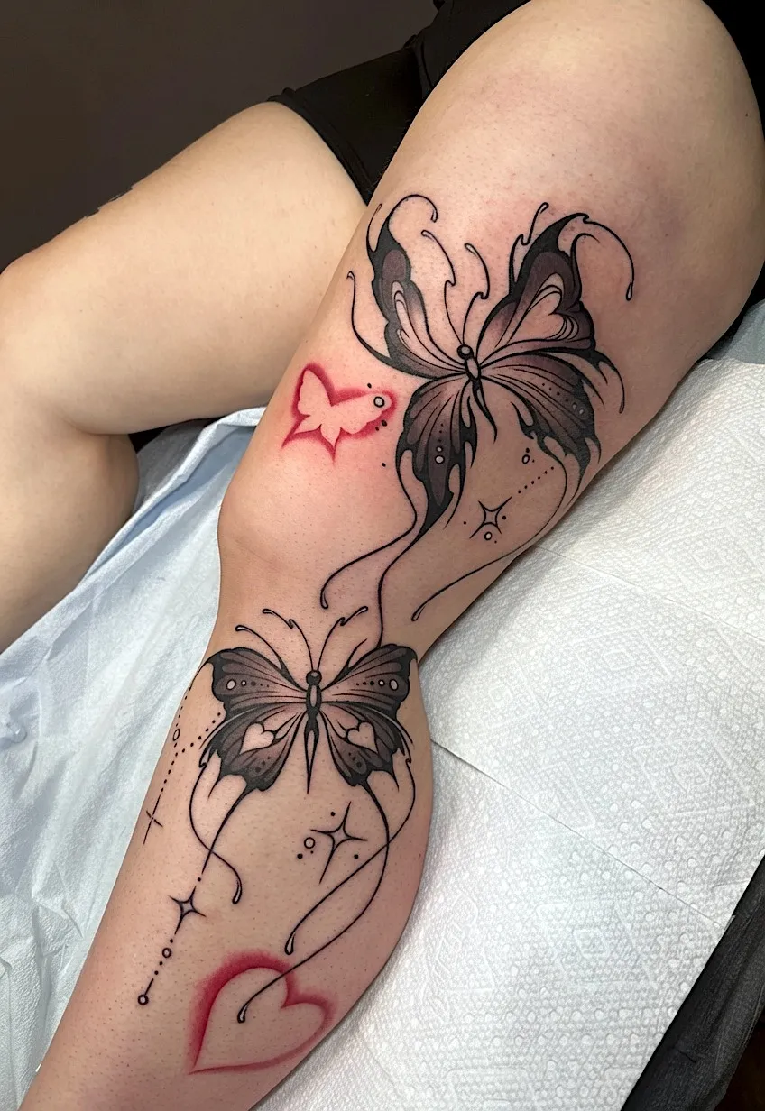 Butterfly tattoos with fine-line swirls and red heart accents
