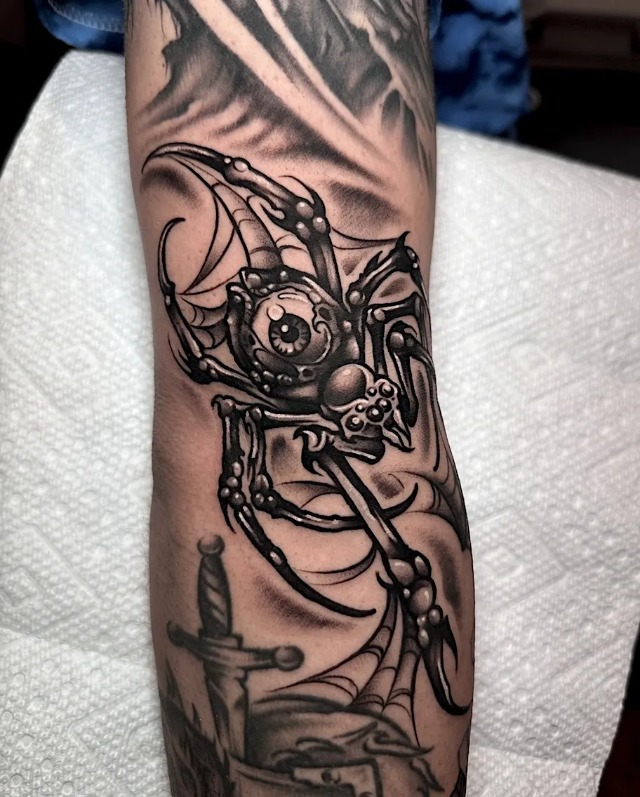 Black and grey mechanical skull tattoo with cables and metal details