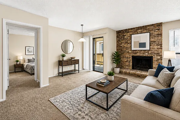 Bright apartment living room with an open layout, cozy seating area, and bedroom entrance, illustrating how to choose the right apartment floor plan for your lifestyle.