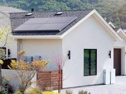 Sleek black 2026 Tesla Solar Panels and premium Tesla Solar Roof elegantly installed on a distinguished luxury home in Draper, Utah with modern architecture and stunning Wasatch Mountain views