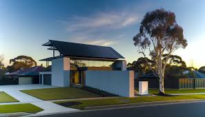 Premium Tesla Solar Roof with sleek black tiles crowning a luxurious Layton home featuring elegant modern architecture and stunning Wasatch Mountain views