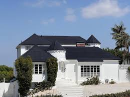 Sleek black 2026 Tesla Solar Panels and premium Tesla Solar Roof unlocking luxury on a distinguished Herriman home with modern architecture and scenic mountain views