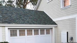 Elegant premium Tesla Solar Roof with sleek black tiles crowning an exclusive Salt Lake City luxury home featuring sophisticated modern architecture and breathtaking mountain views