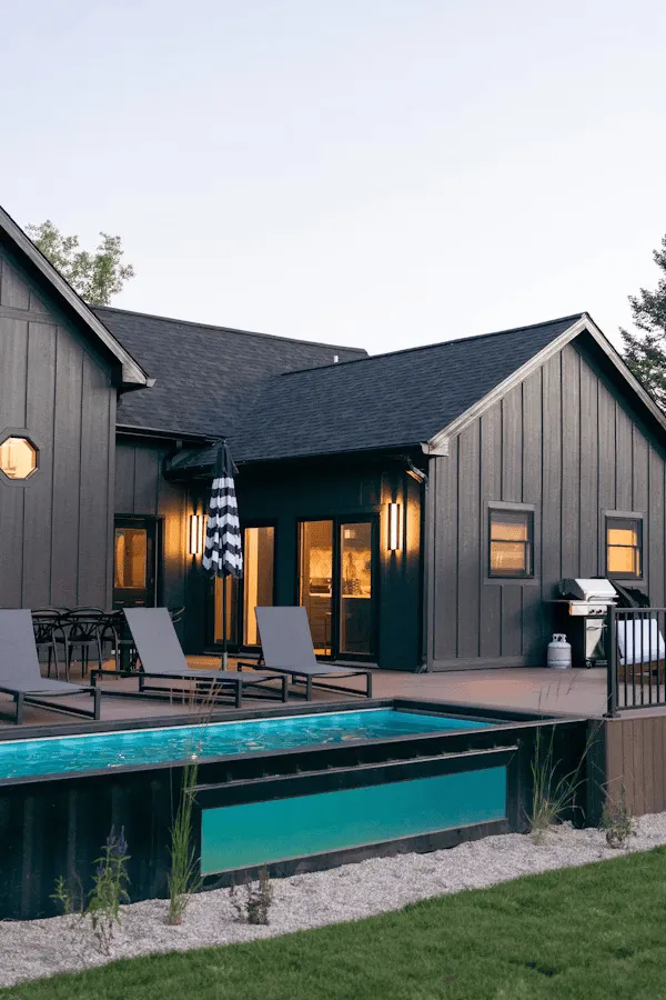 Premium Tesla Solar Roof with sleek black tiles elegantly installed on a luxurious Layton home featuring modern architecture and stunning mountain views