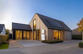 Luxurious St. George home featuring sleek black 2026 Tesla Solar Panels alongside an elegant premium Tesla Solar Roof with modern desert architecture and breathtaking red rock mountain views