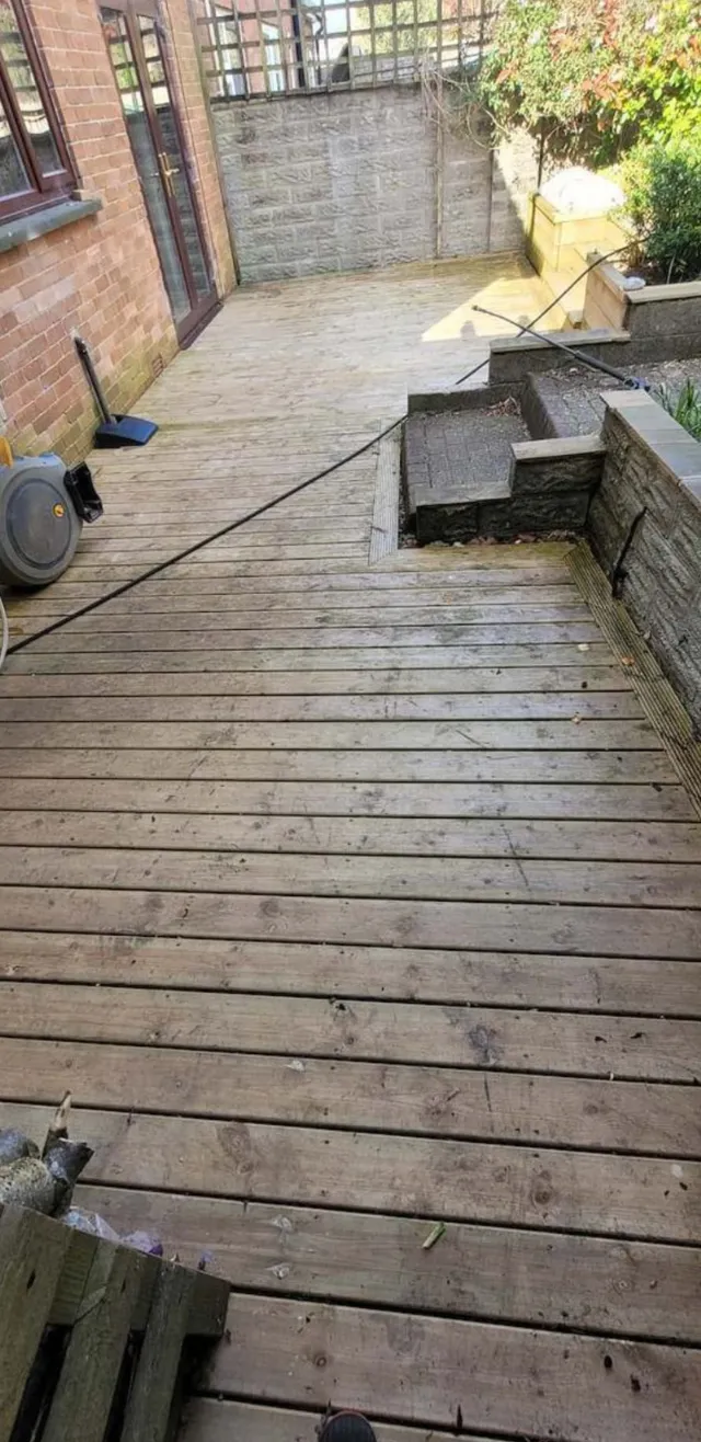 Before photo of a pressure washing project on some decking in Cardiff