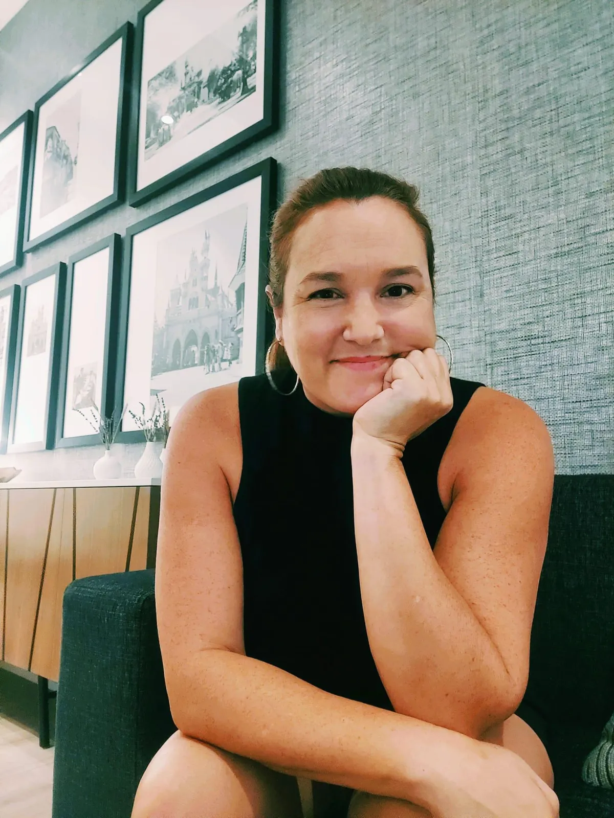 Warm glass of gut health drink with citrus and herbs on a wooden table