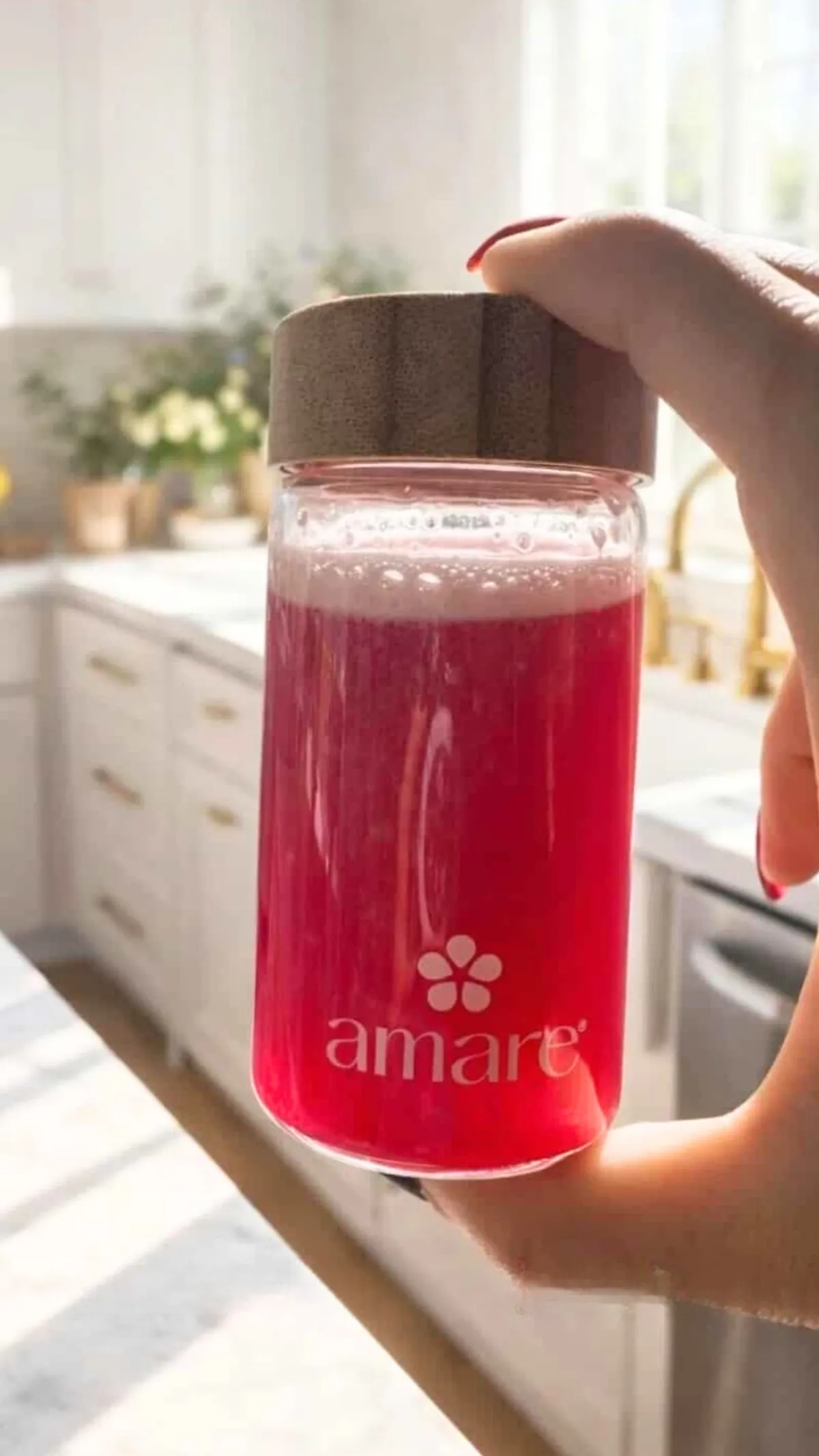 Warm glass of gut health drink with citrus and herbs on a wooden table