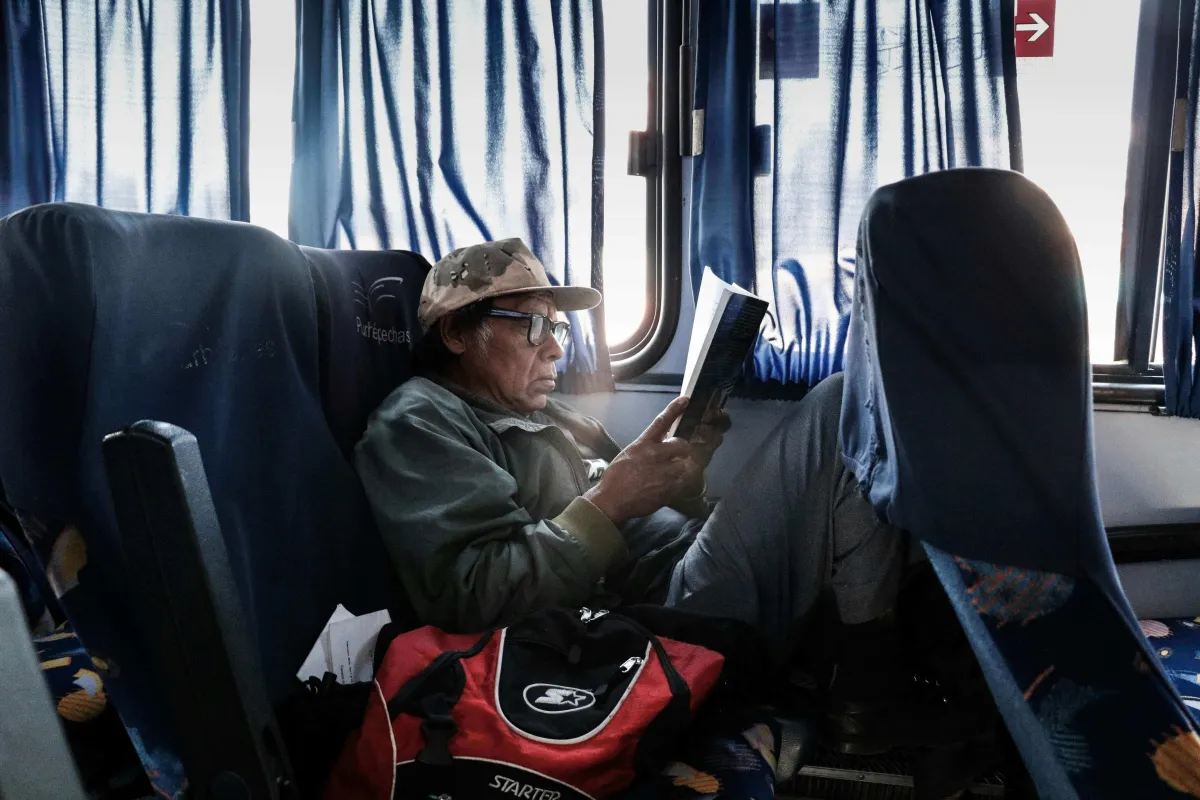 Old man reading plans while traveling