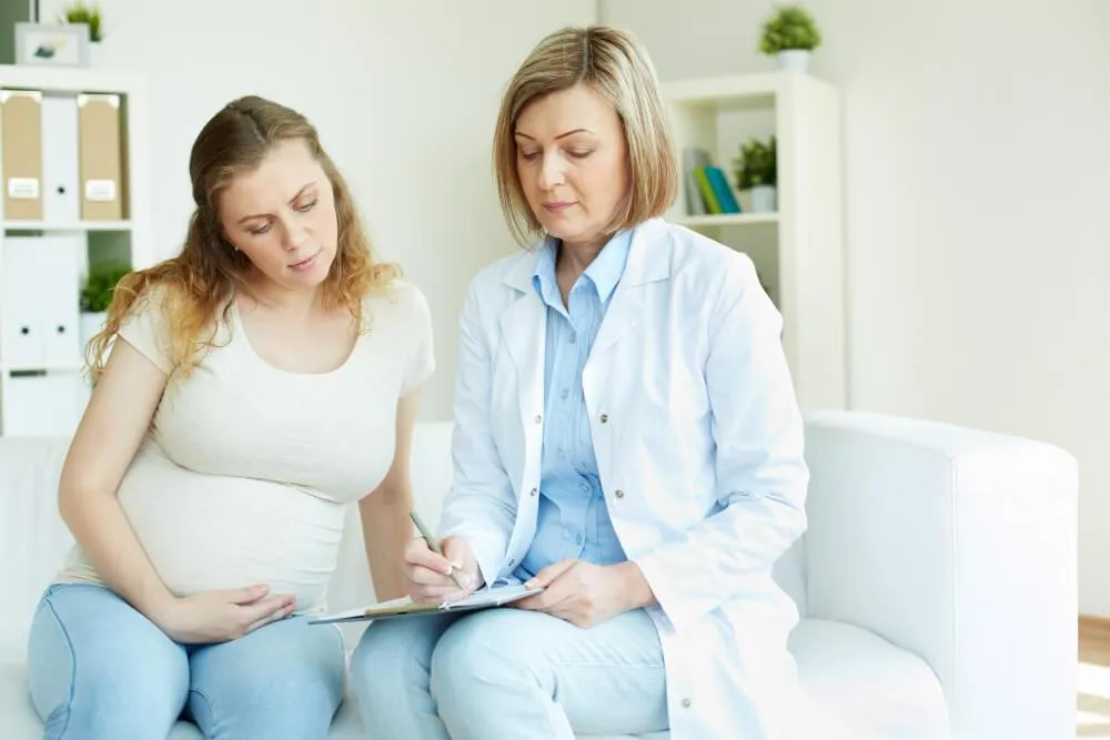 Doctor discussing findings on woman's checkup on her pregnancy
