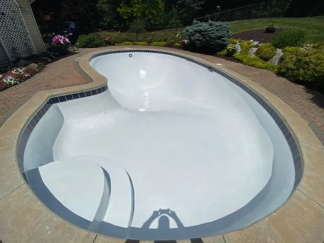 Newly installed crisp white vinyl pool liner in a residential inground pool following a liner replacement in Rockford, MI by Fizer Pools