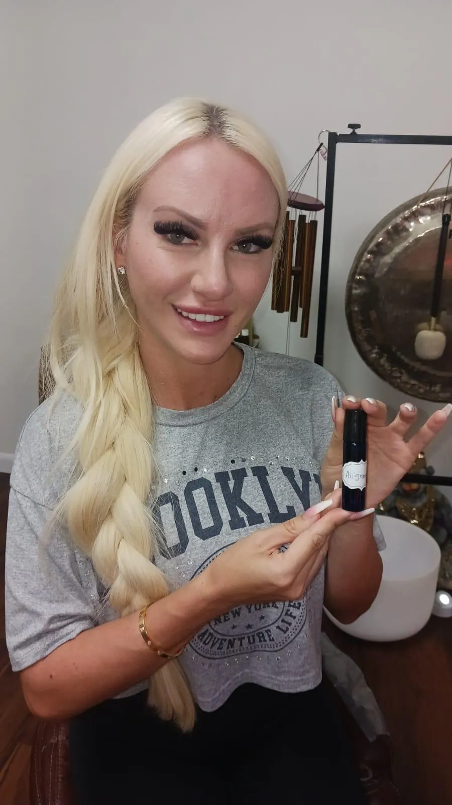 A person holding a botte of essential oils she made to take home from her reiki session