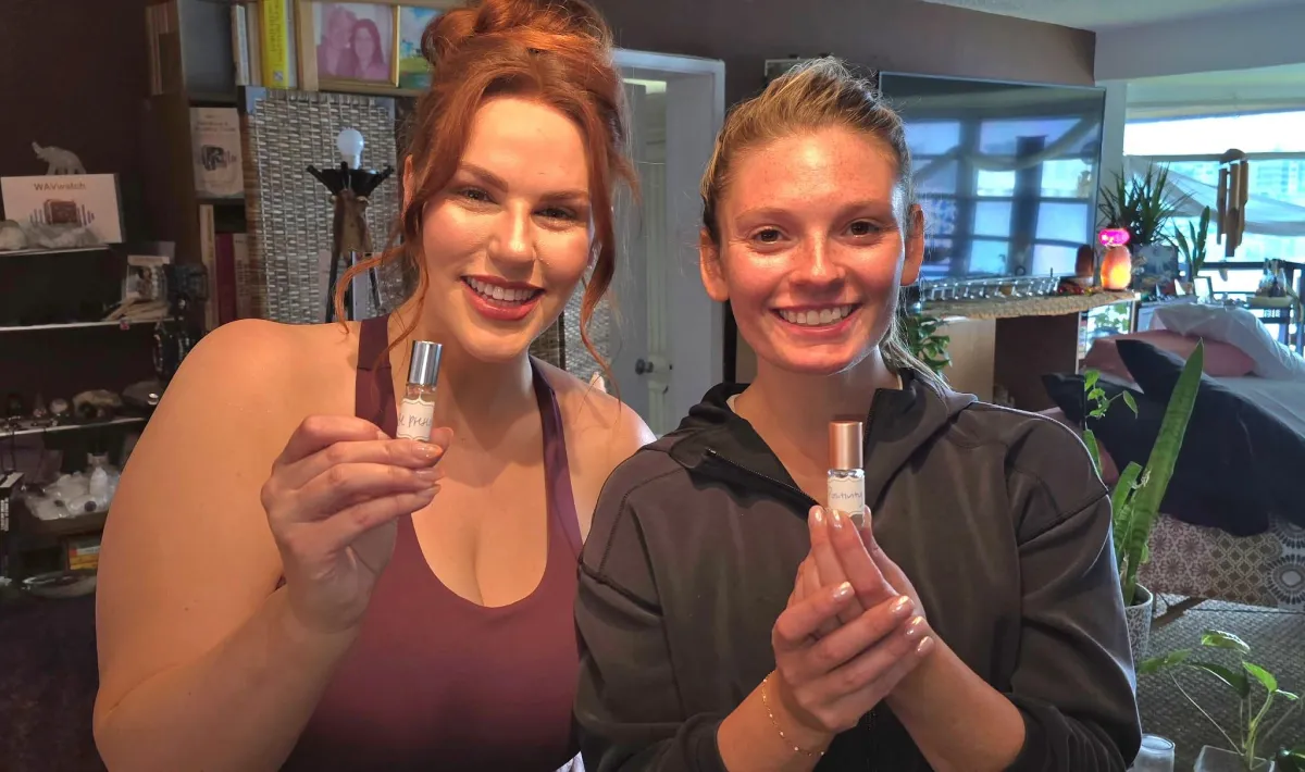 A person holding a botte of essential oils she made to take home from her reiki session