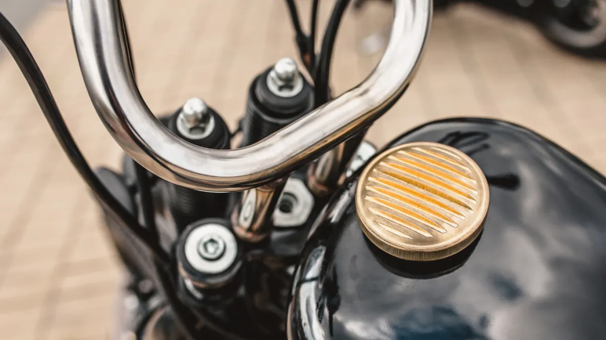 Black steel gas tank with a bronze cover