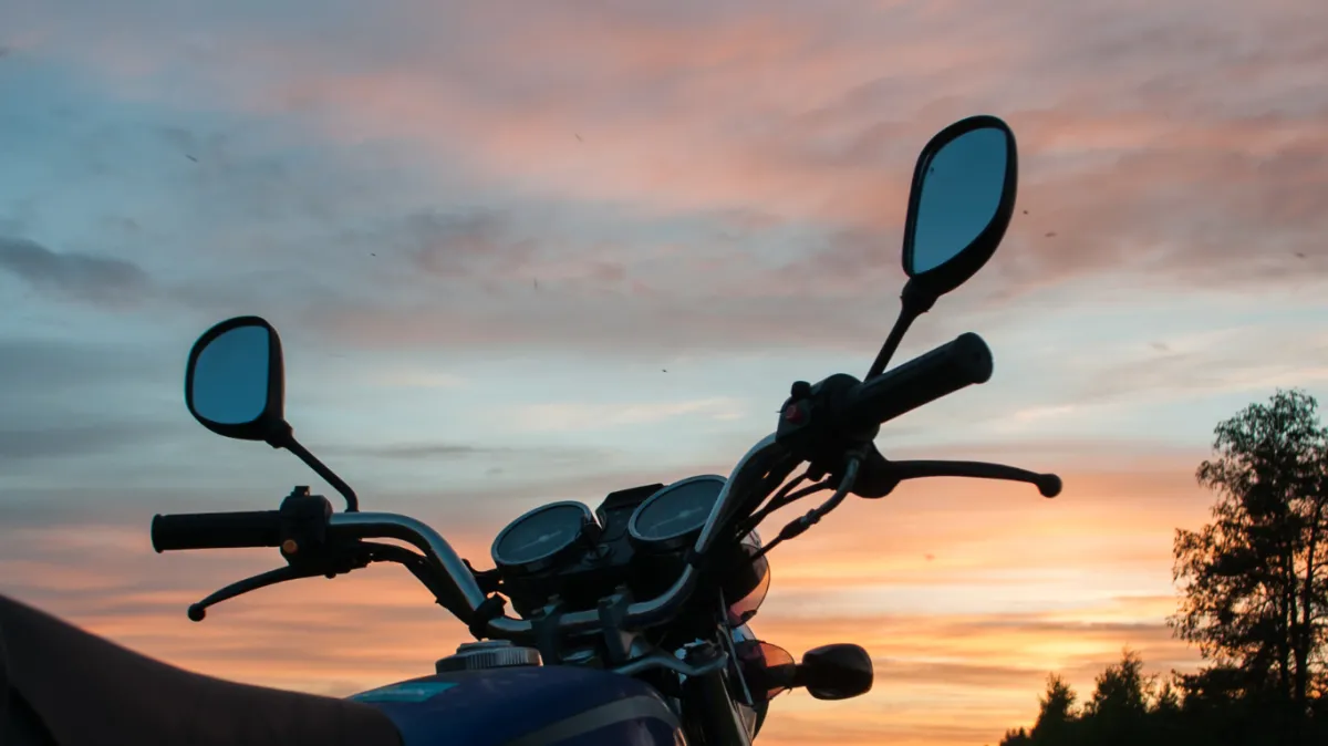 Handlebar motorcycle close-up on sunset background