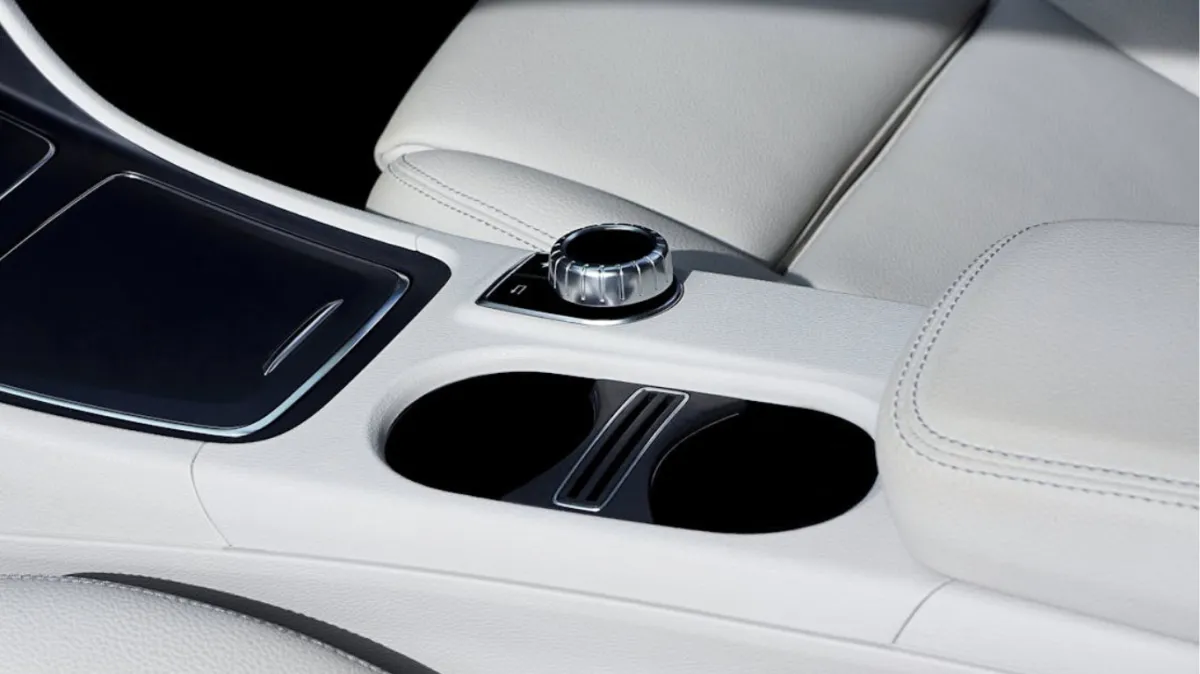 Luxury car interior with white leather seats.