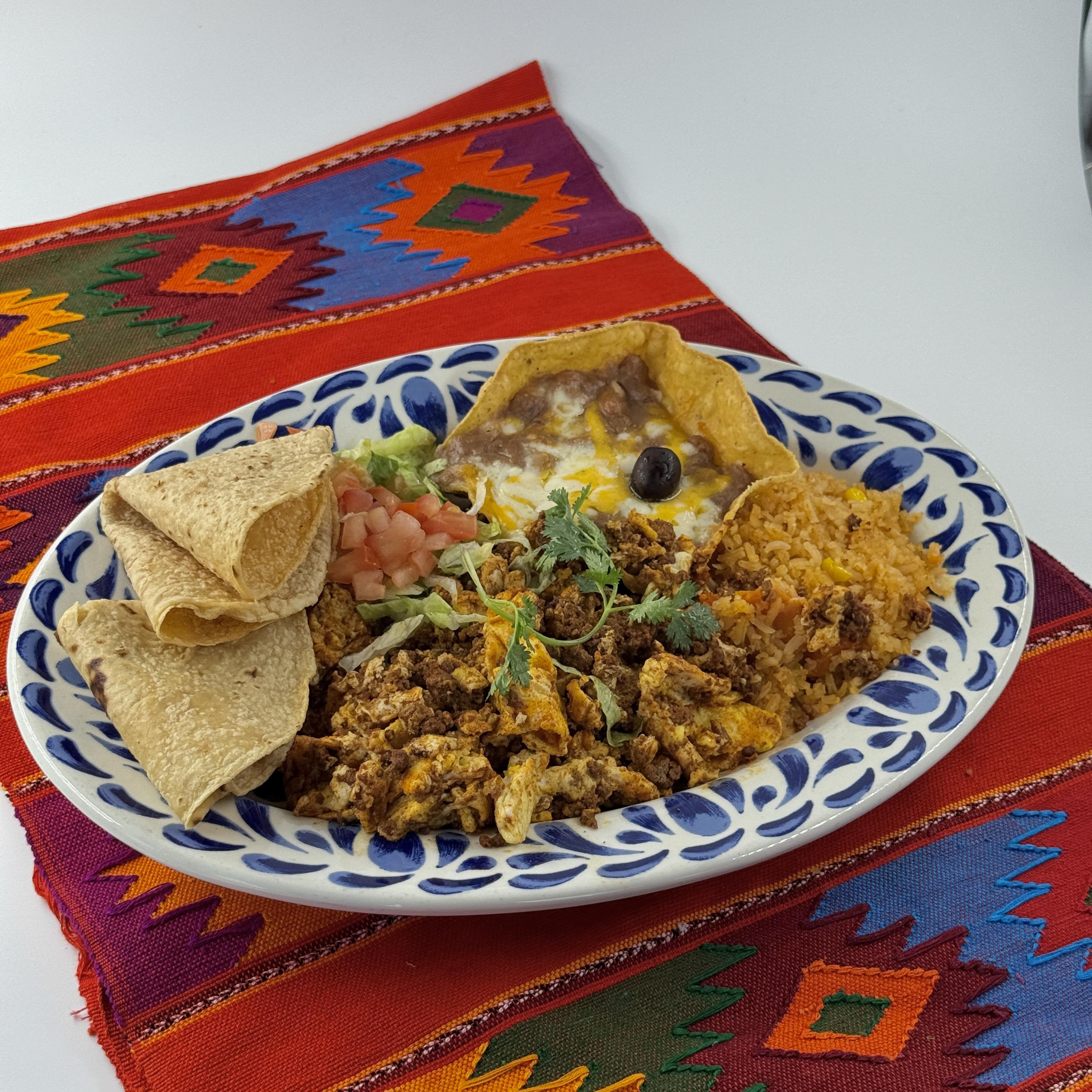 Casa de Pico Almuerzos menu: huevos con chorizo plate with rice, beans and warm tortillas