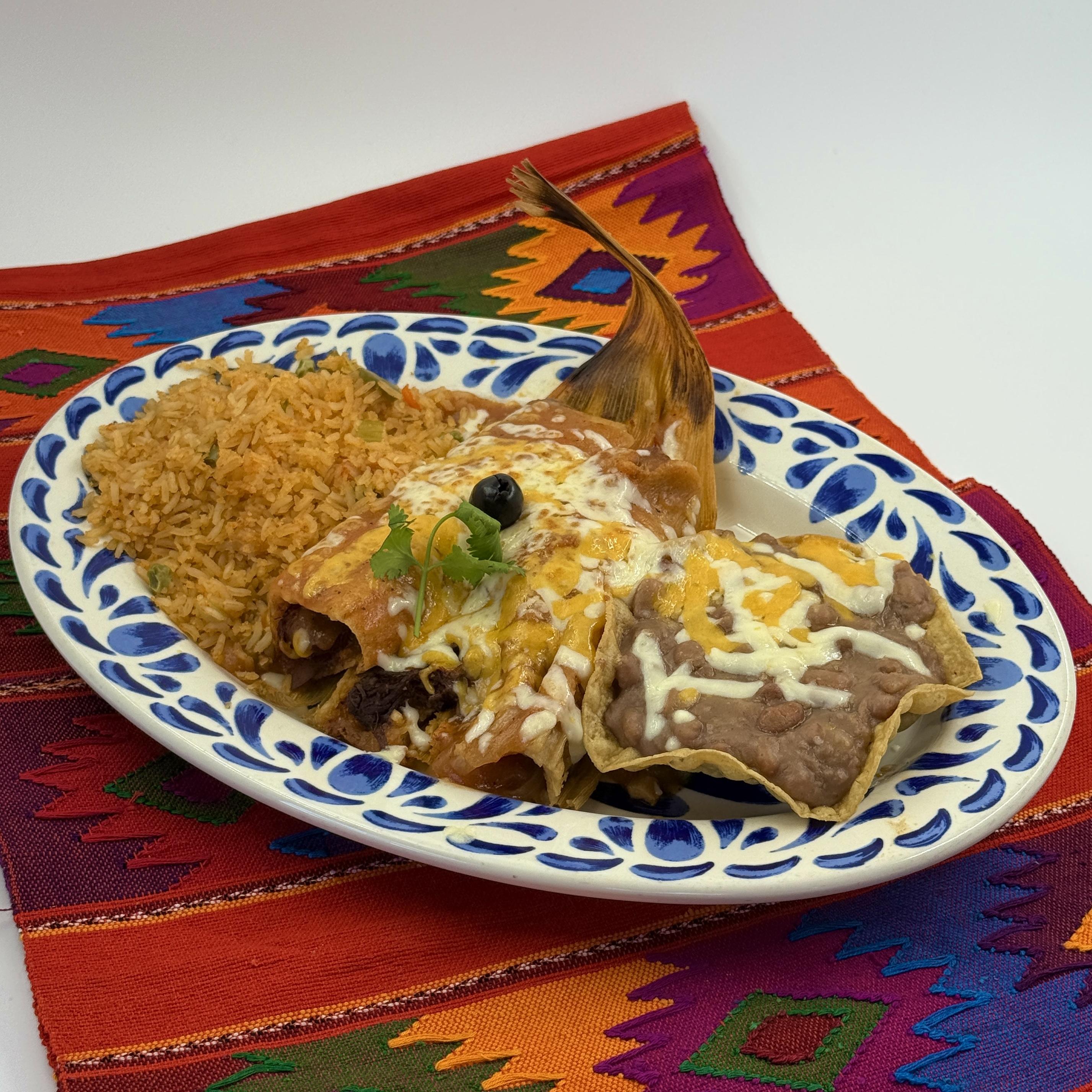 TAMALES, Two homemade chicken or beef tamales topped with salsa espan˜ola and cheese. Served with rice and refried beans.