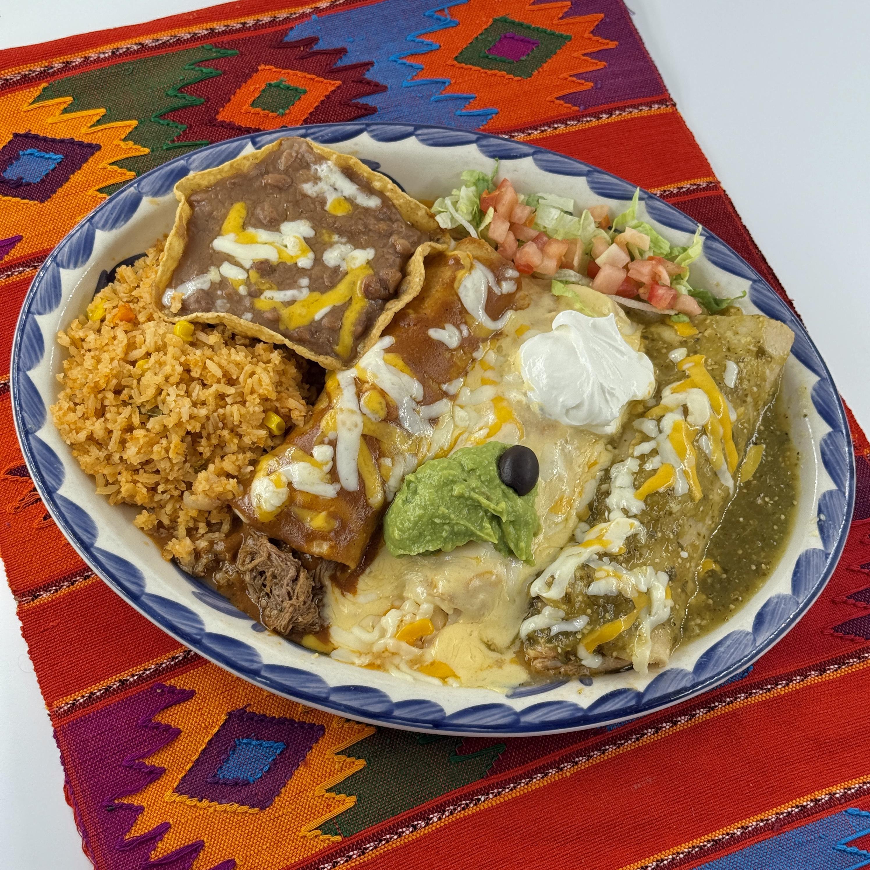 ENCHILADAS BANDERAS, Three enchiladas: one white cheese, one red beef and one green chicken. Served with rice and refried beans topped with sour cream and guacamole