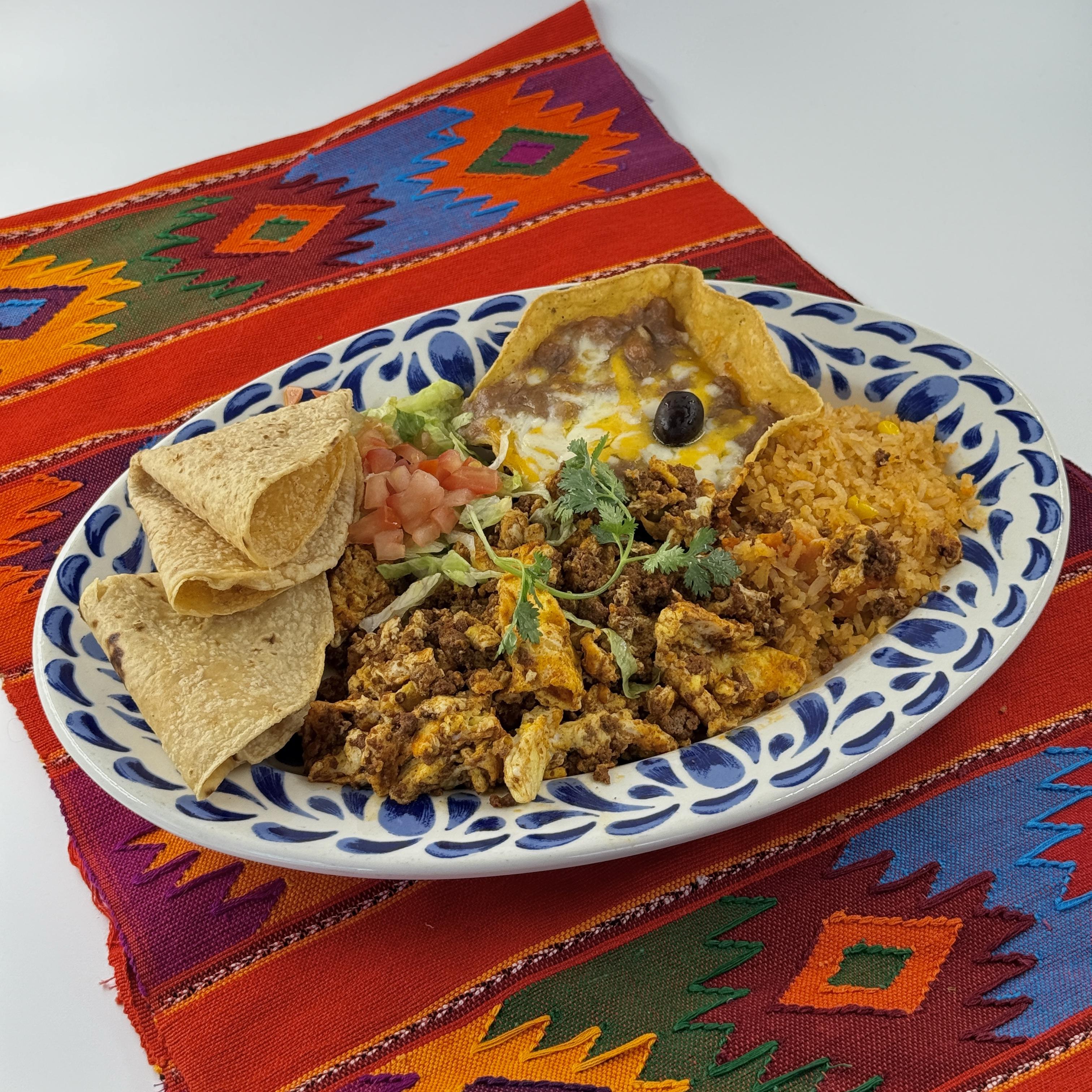 Huevos con Chorizo,Spicy Mexican Sausage scrambled together with two fluffy eggs.