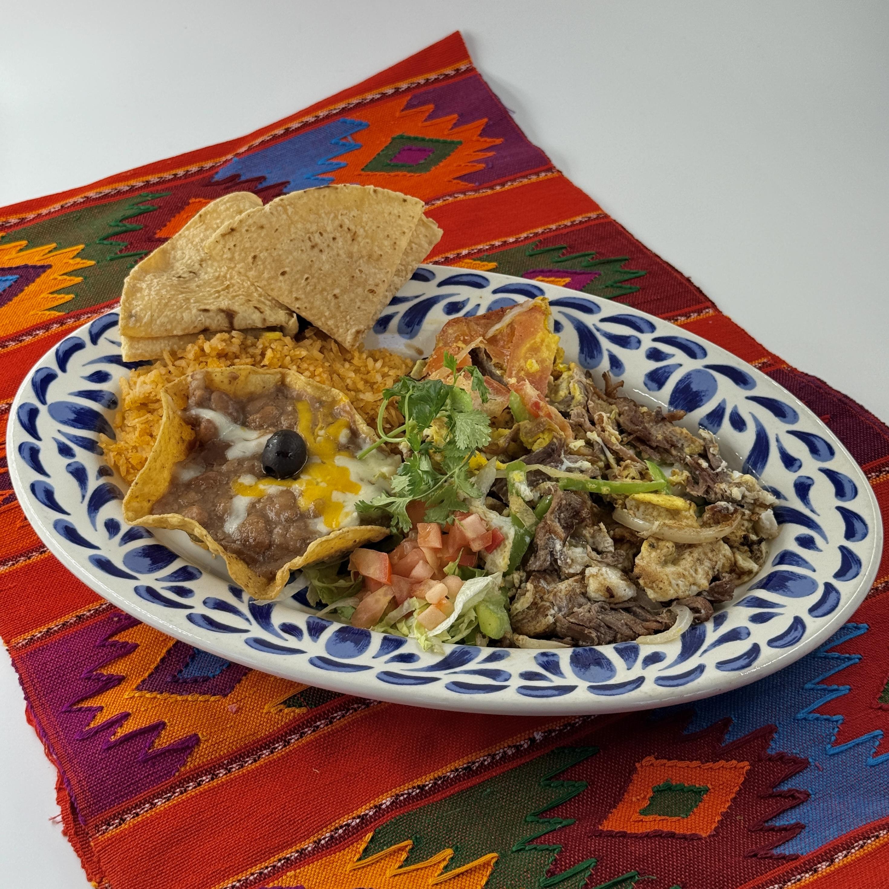 Casa de Pico Almuerzos menu: machaca shredded beef and eggs with rice, beans and tortillas