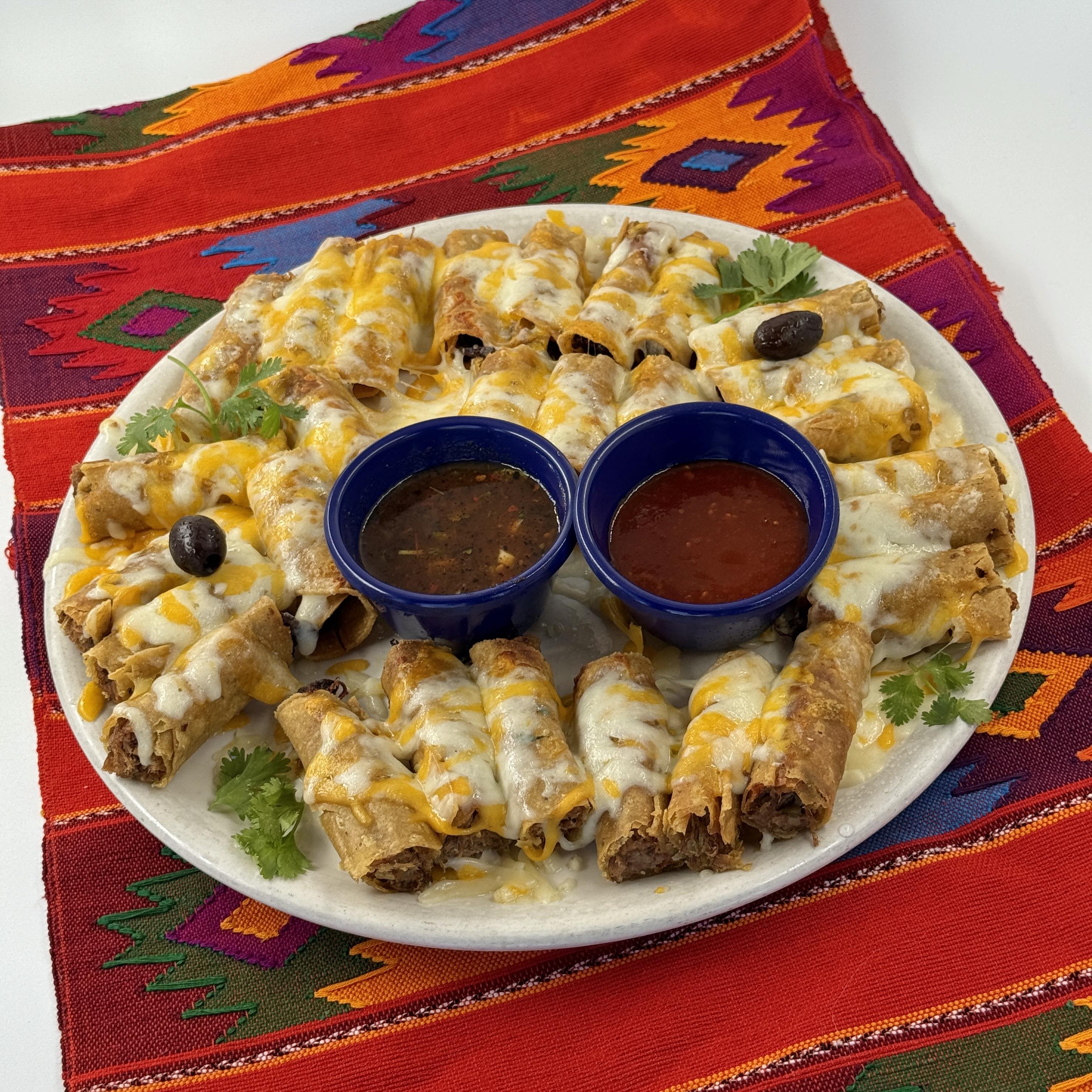 Casa de Pico muchísimos taquitos with melted cheese and salsa