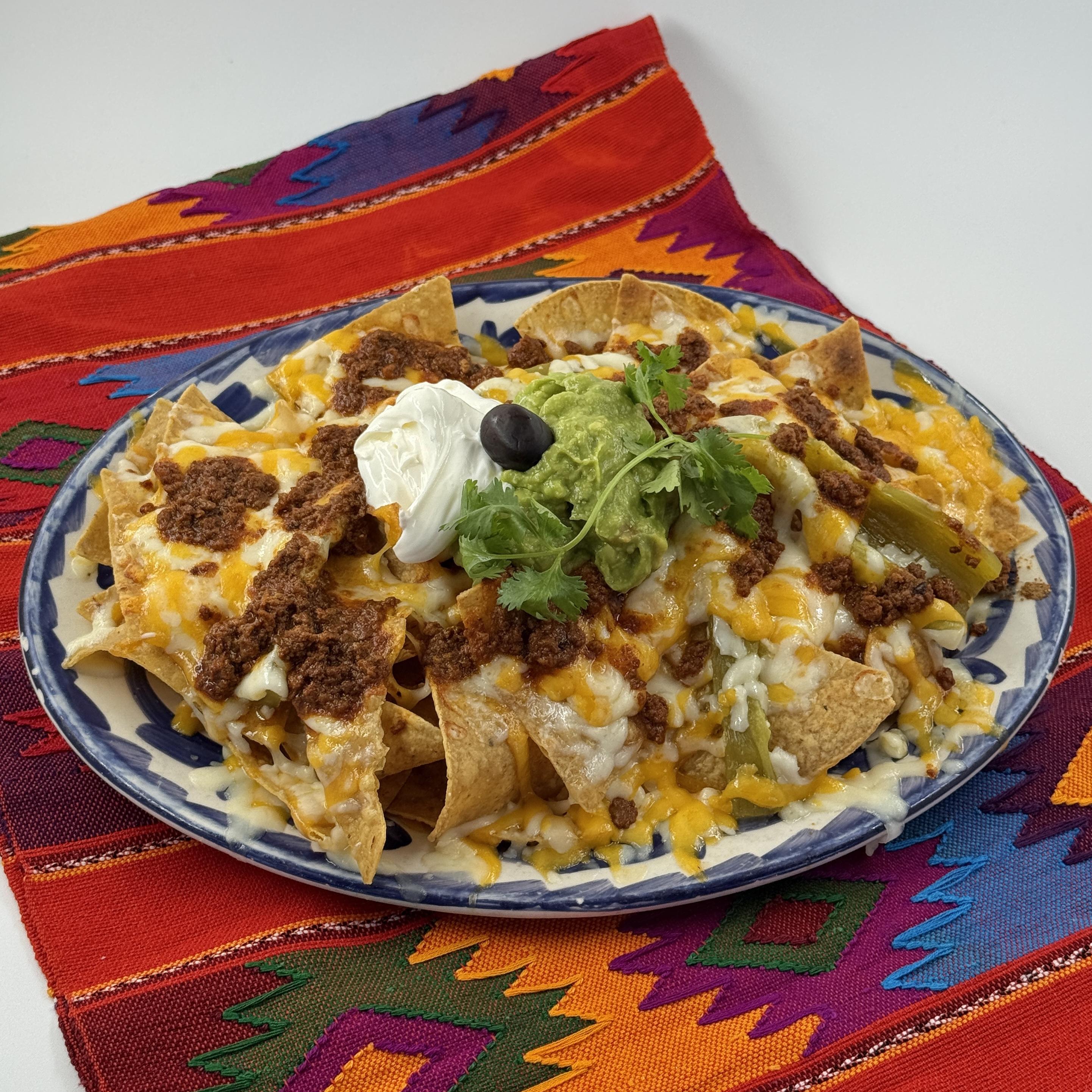 Nacho Supremos- A towering feast of crisp, golden tortilla chips generously smothered with perfectly melted cheese. We layer on spicy chorizo, a dollop of cool sour cream, and fiery jalapeños to bring the heat. Our homemade guacamole for a smooth counterpoint to the crunch of the chips and then topped with homemade salsa.