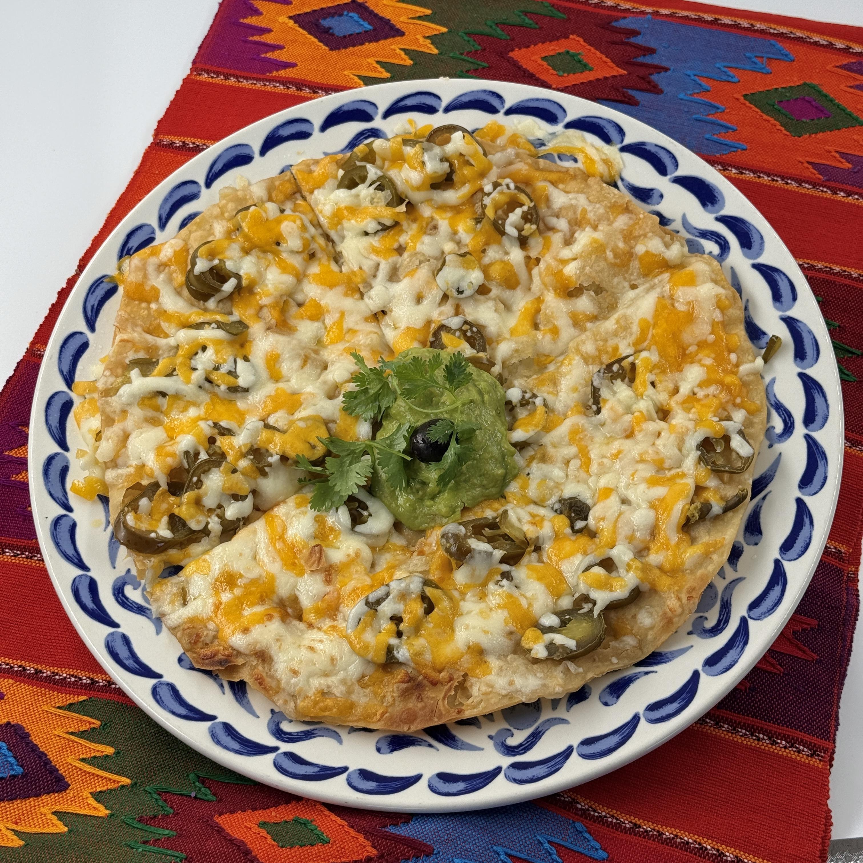 Casa de Pico cheese crisp special with beans, melted cheese, avocado, tomato, guacamole and sour cream